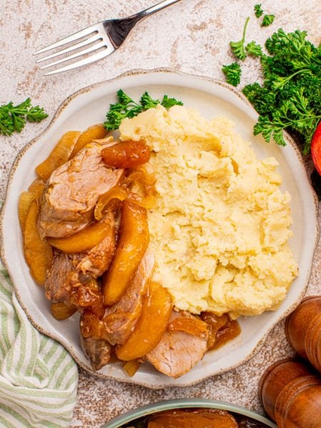 Slow Cooker Apple Pie Pork Tenderloin on a plate with mashed potatoes