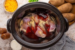 chicken breasts, BBQ sauce, garlic powder, onion powder, salt, and pepper to the crockpot