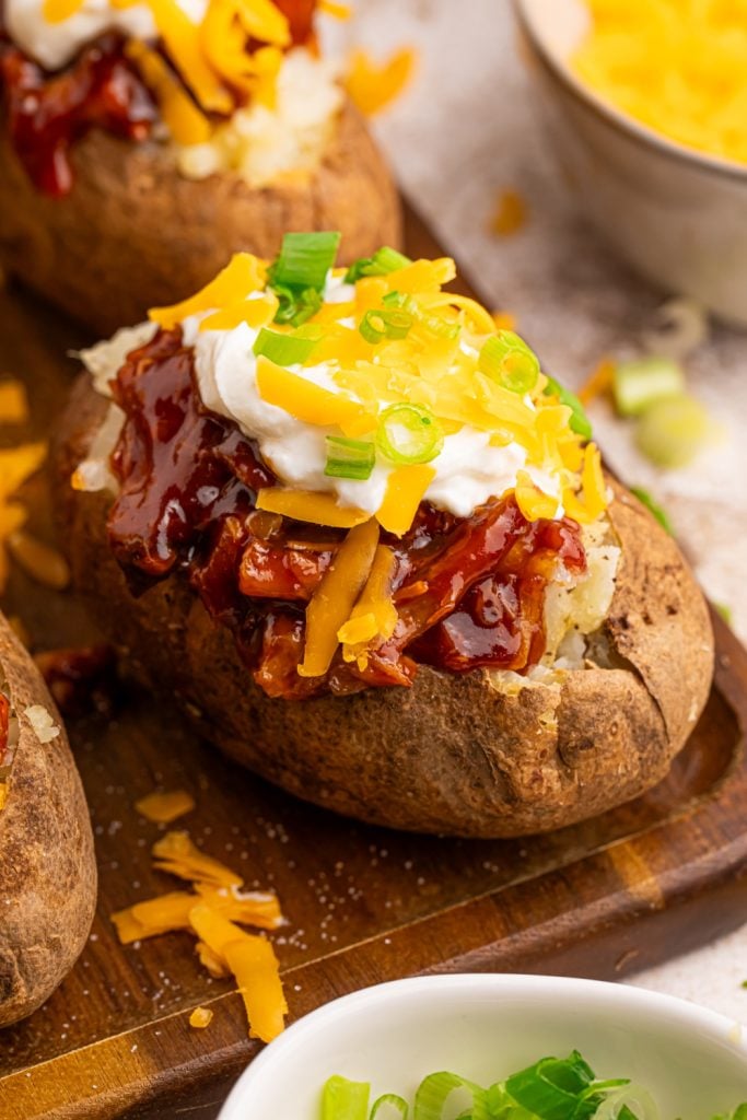 W cookware grilled chicken fills the cutting board with baked potatoes
