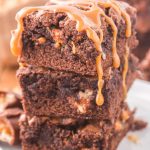 Snickers Brownies stacked on a plate