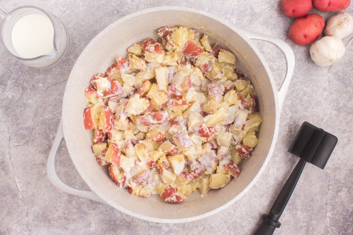 Add cooked potatoes to the pan with melted butter
