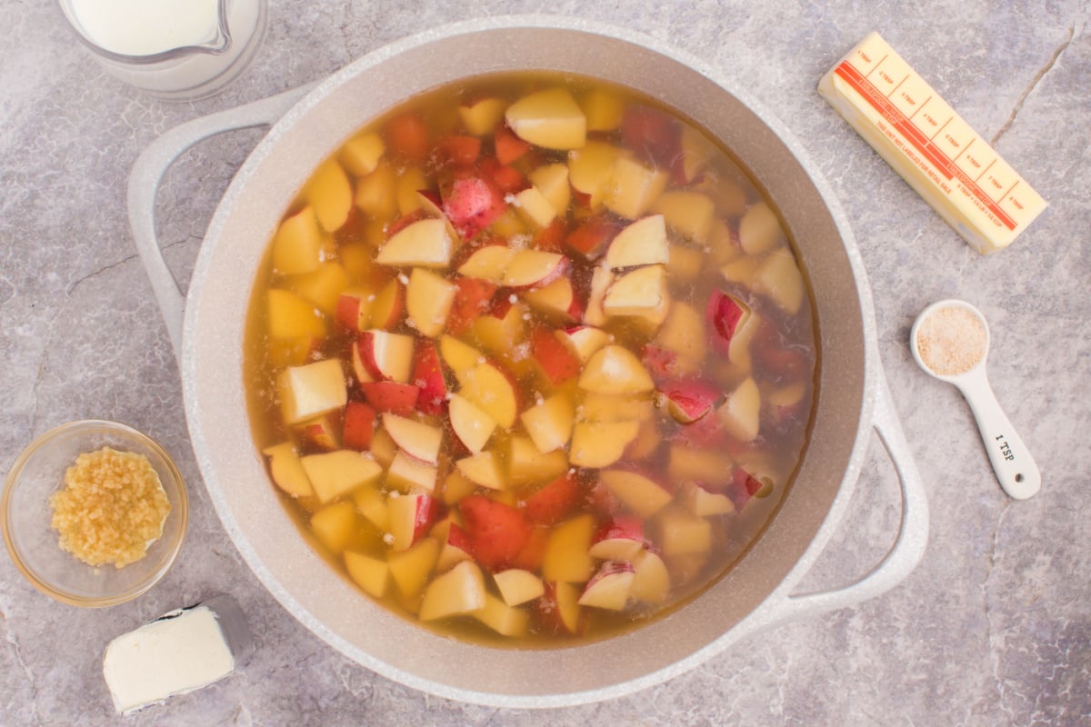 Cut potatoes in cooking pot
