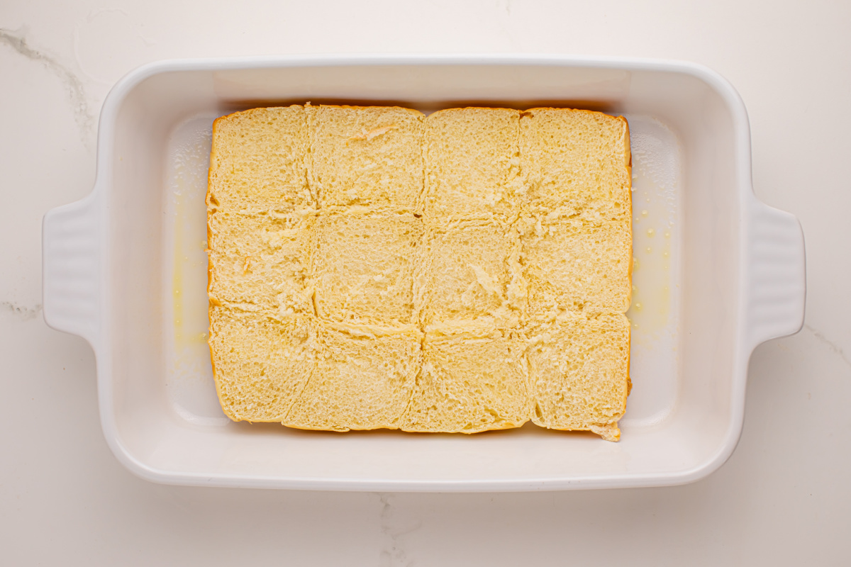 Place the bottom half of the roll into the baking pan