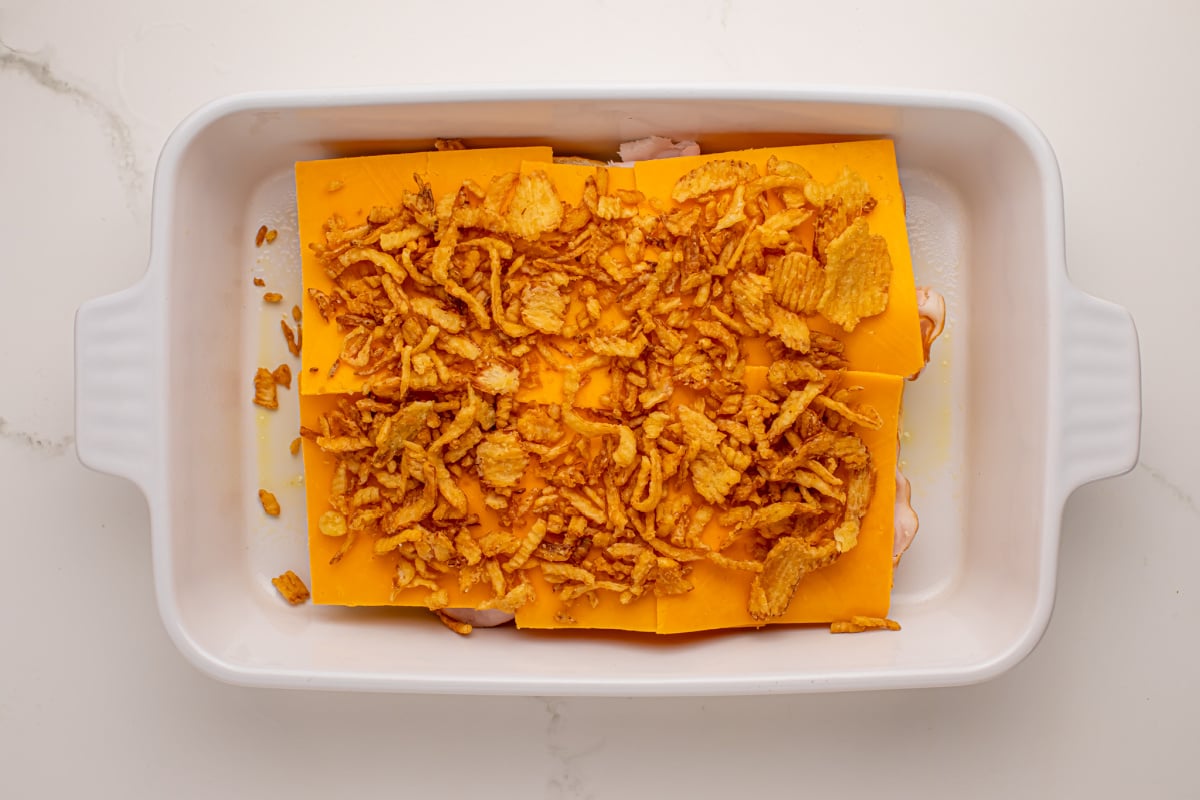 Add fried onion slices to top of cheese