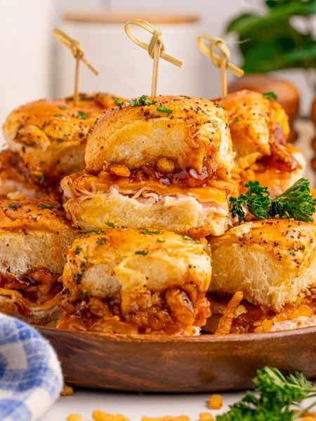 BBQ Deli Chicken Sliders stacked on a plate