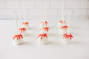 Bloody Halloween Cake Pops lined up on a table