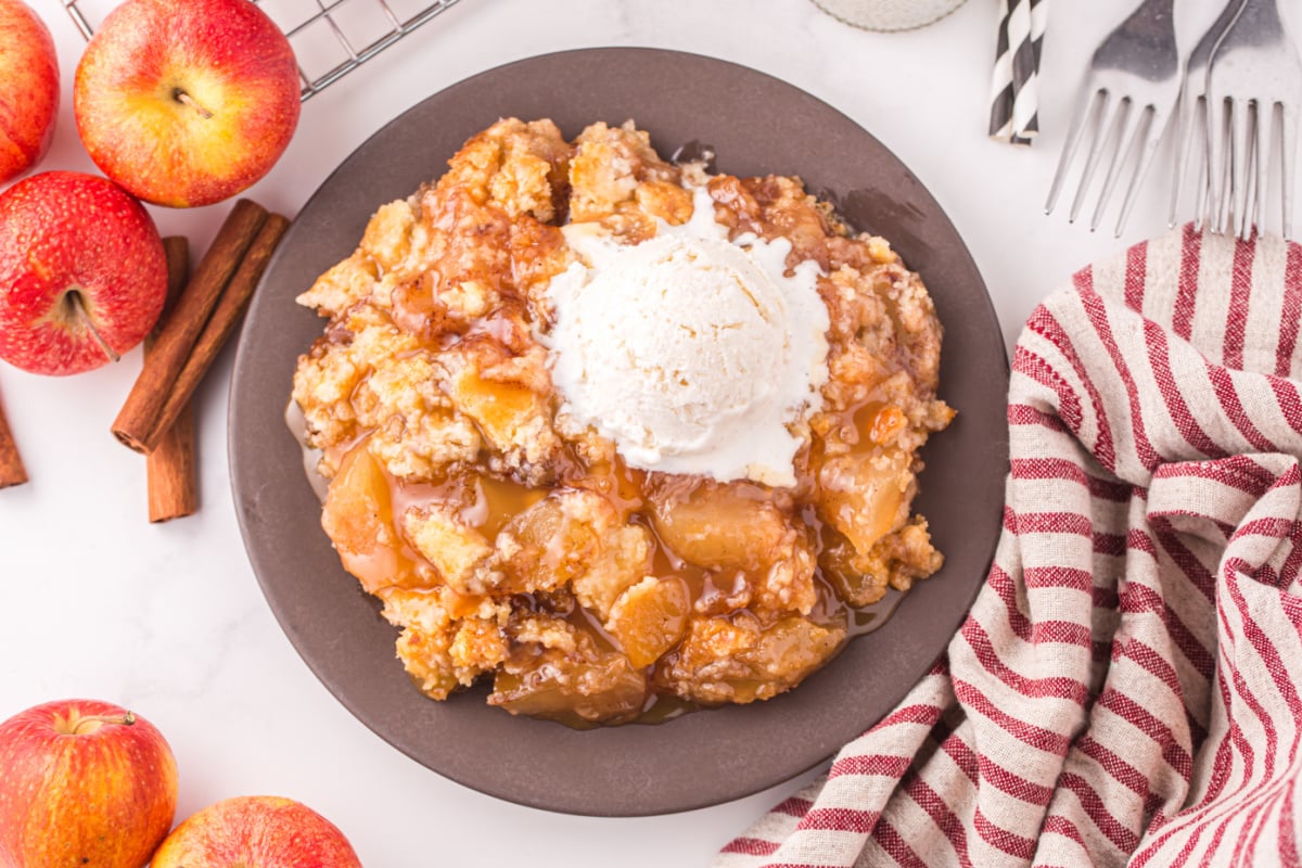 Caramel apple cake on a plate with ice cream