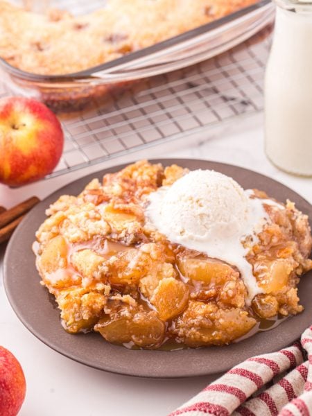 Caramel Apple Dump Cake on a plate with ice cream