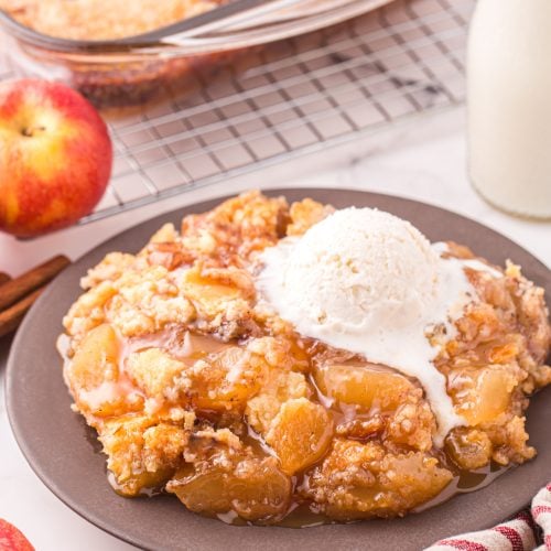 Caramel apple cake on a plate with ice cream