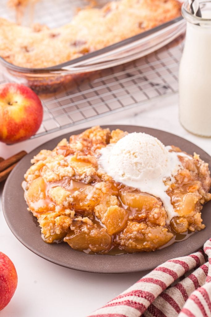 Caramel apple cake on a plate with ice cream
