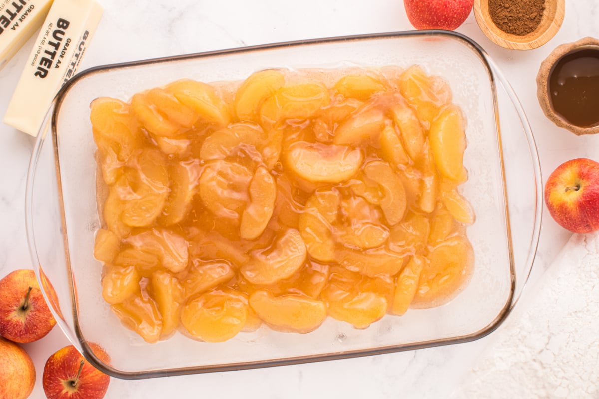 Apple pie filling placed in baking dish