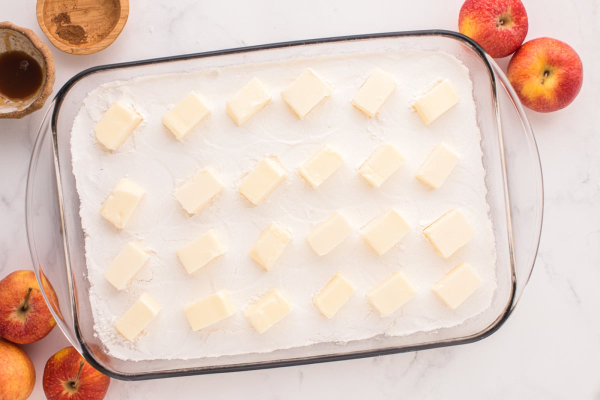 Butter slices placed on top of cake mixture