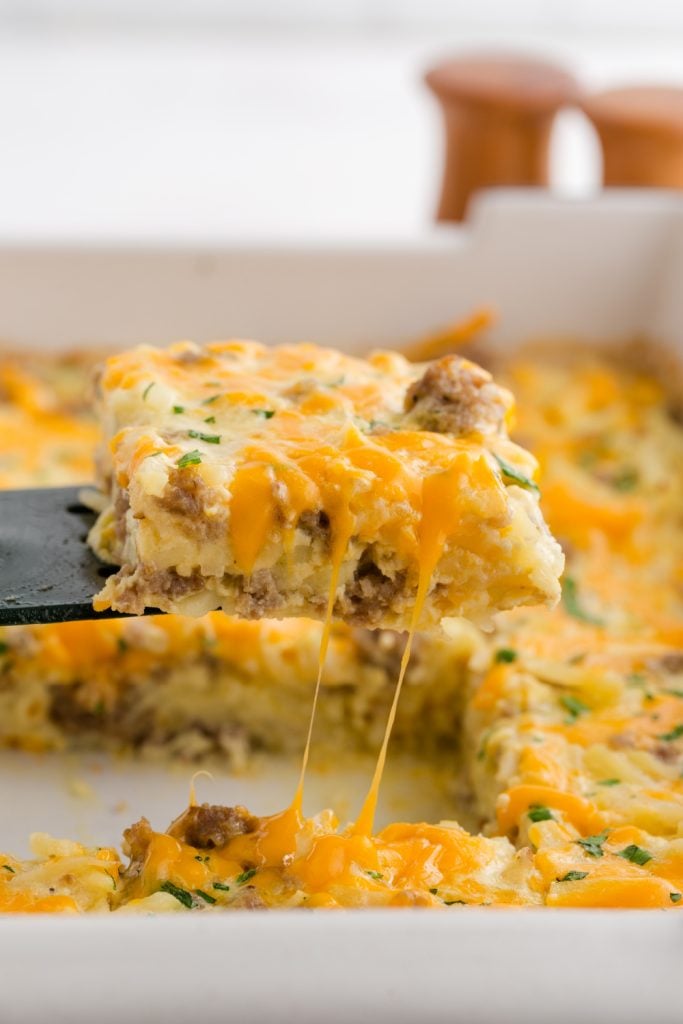 Scoop hash brown breakfast casserole with spatula