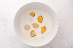 eggs, half and half, dijon mustard, salt and garlic powered in a mixing bowl