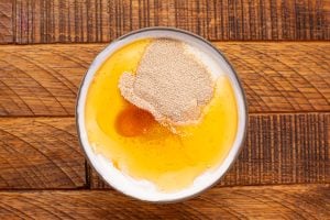 honey, yeast, sour cream in a bowl