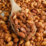 slow cooker candied mixed nuts on a baking sheet