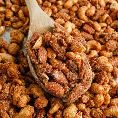 slow cooker candied mixed nuts on a baking sheet
