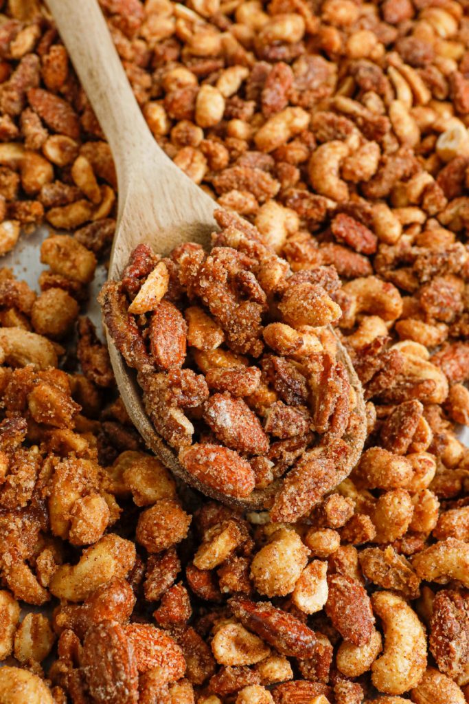 slow cooker candied mixed nuts on a baking sheet