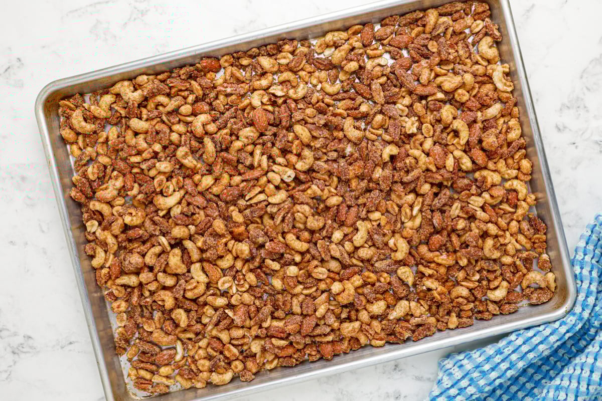 slow cooker candied mixed nuts on a baking sheet