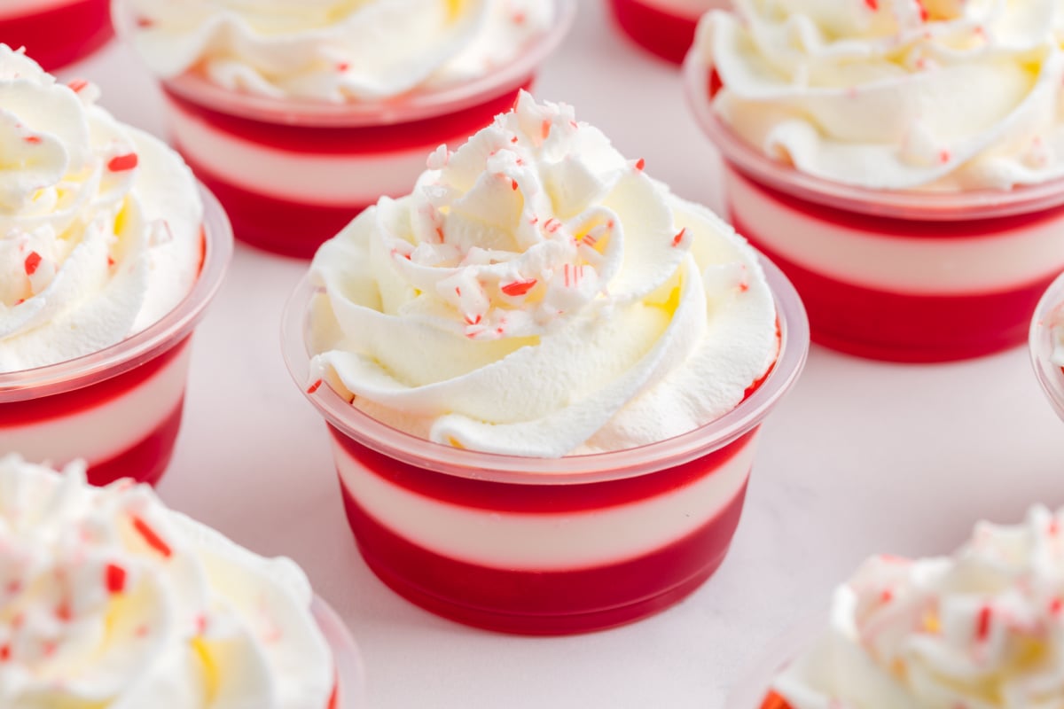 whipped cream and crushed candy canes added to top of jello shots