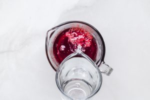pouring warm water into jello mix