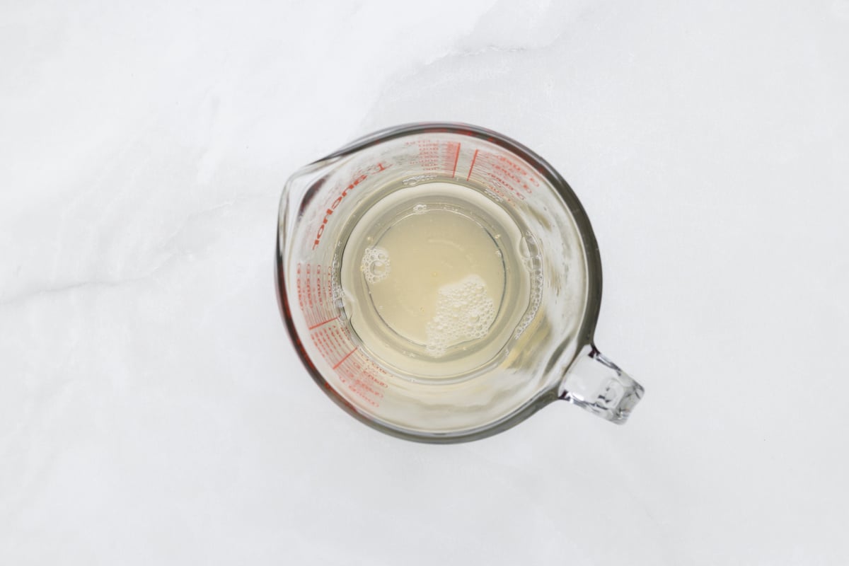 water mixed with gelatin in measuring cup 