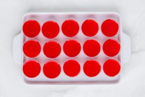 another layer of red jello added to shot glasses