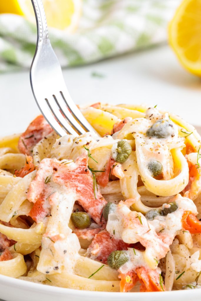 Place creamy smoked salmon pasta on plate with fork