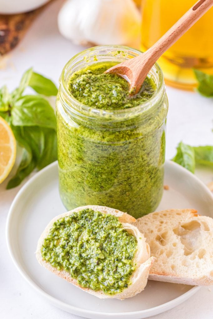 Place homemade pesto in a jar and spread on a piece of bread