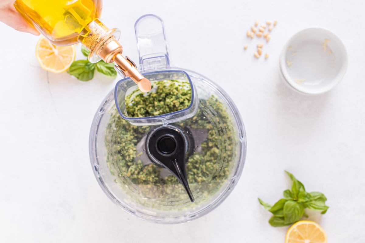 Pour olive oil into food processor