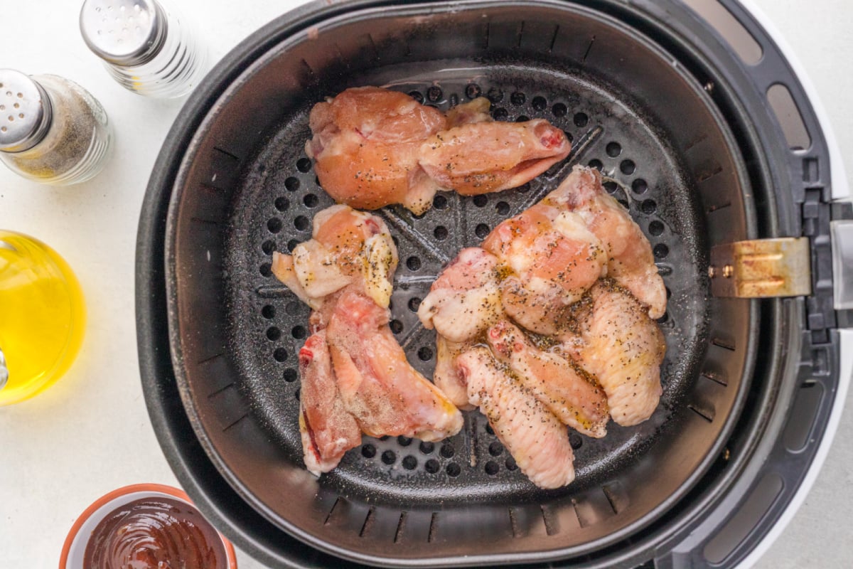 Season the chicken wings in the air fryer