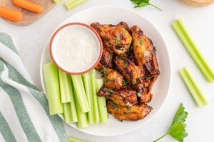 AIR FRYER FROZEN CHICKEN WINGS on a plate with celery