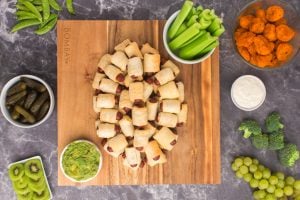 more pig in a blanket added to fill out football shape