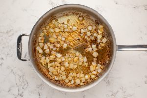 diced onion and broth in a pan