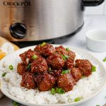 slow cooker mongolian meatballs on a plate with rice