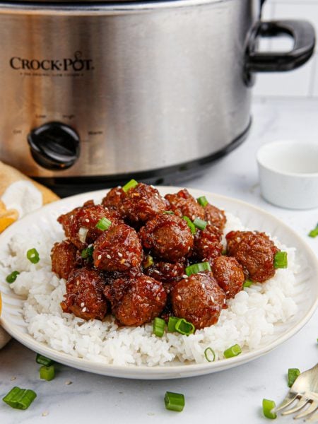 slow cooker mongolian meatballs on a plate with rice