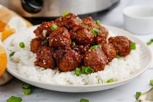 slow cooker mongolian meatballs on a bed of rice