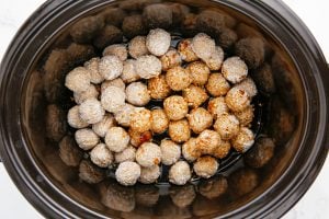 sauce poured over meatballs