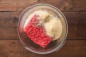 ground beef, crushed saltine crackers, milk, 1 teaspoon of the salt, black pepper, Italian seasoning, and garlic powder in a mixing bowl