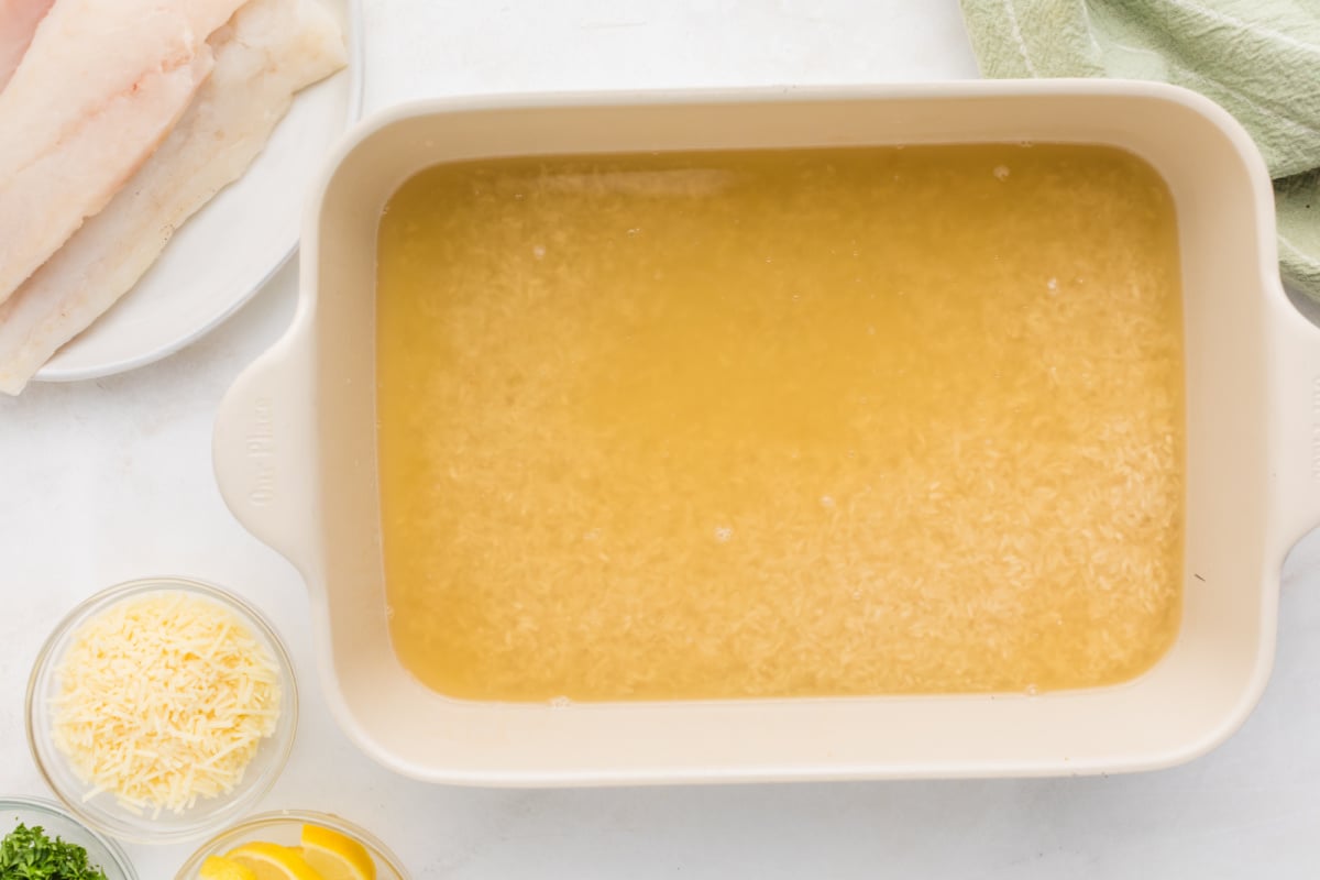 Stock and rice in baking pan