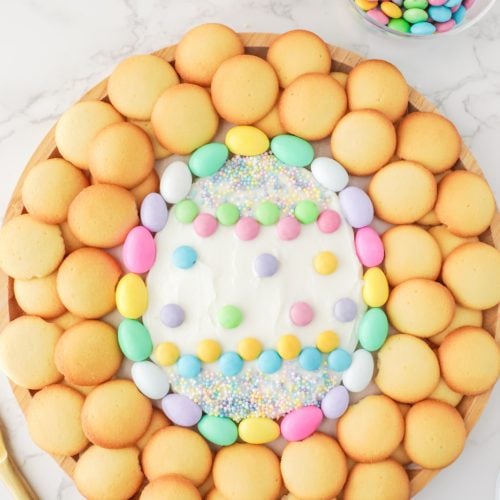 Easter egg frosting plate surrounded by cookies