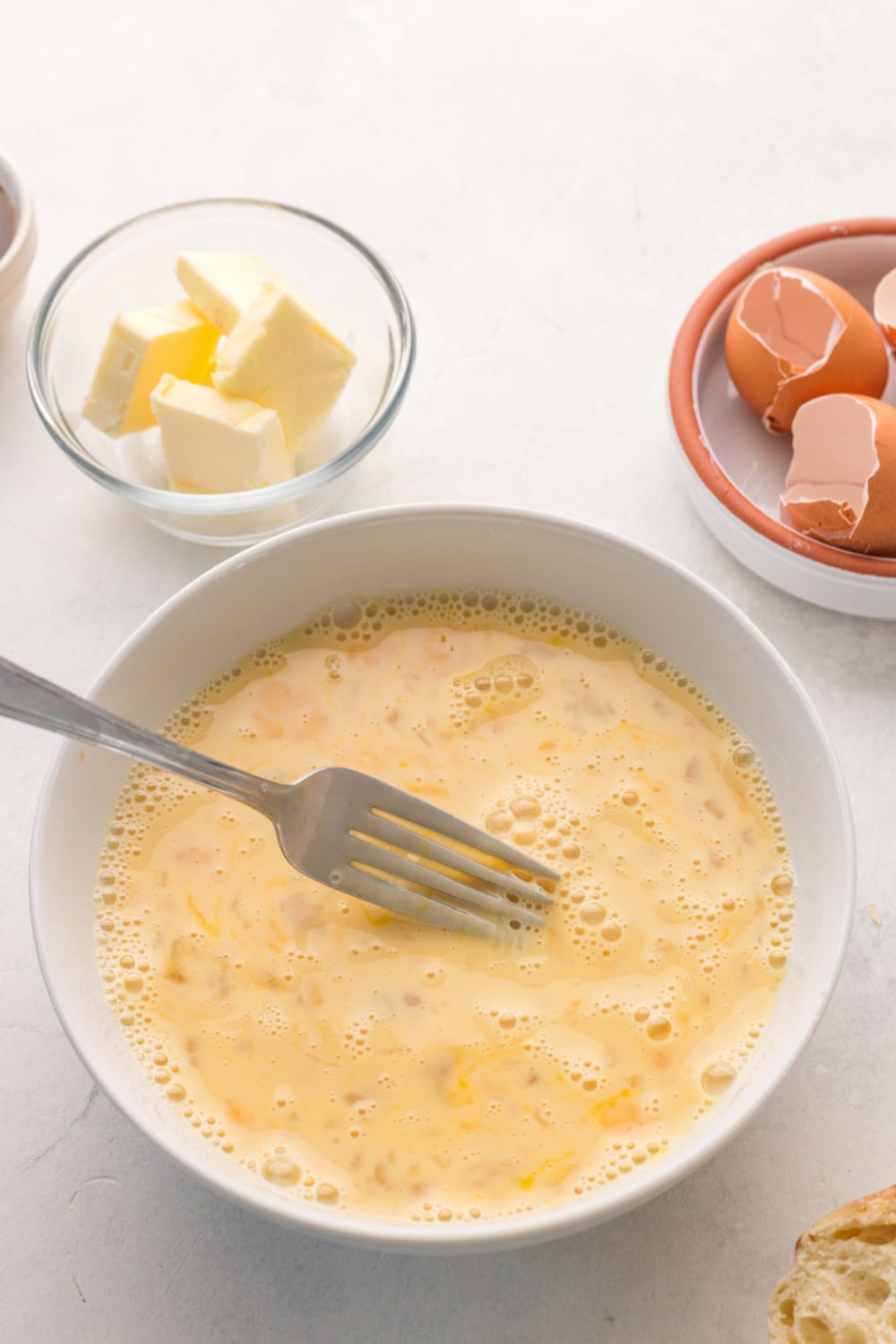 milk, eggs, sugar, and vanilla extract mixed in a bowl