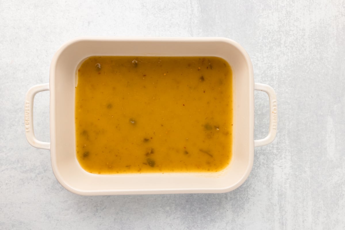 Green sauce on the bottom of the baking dish