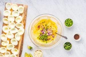mayo, Dijon mustard, grilled corn, red onion, jalapeño, and lime juice added to bowl with yolks