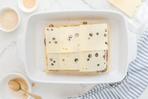 sliced cheese on top of mushrooms and onions