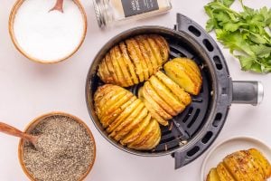 Air Fryer Garlic Butter Hasselback Potatoes in an air fryer basket