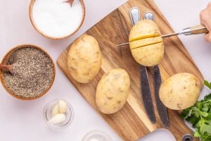 cutting slices into a potato