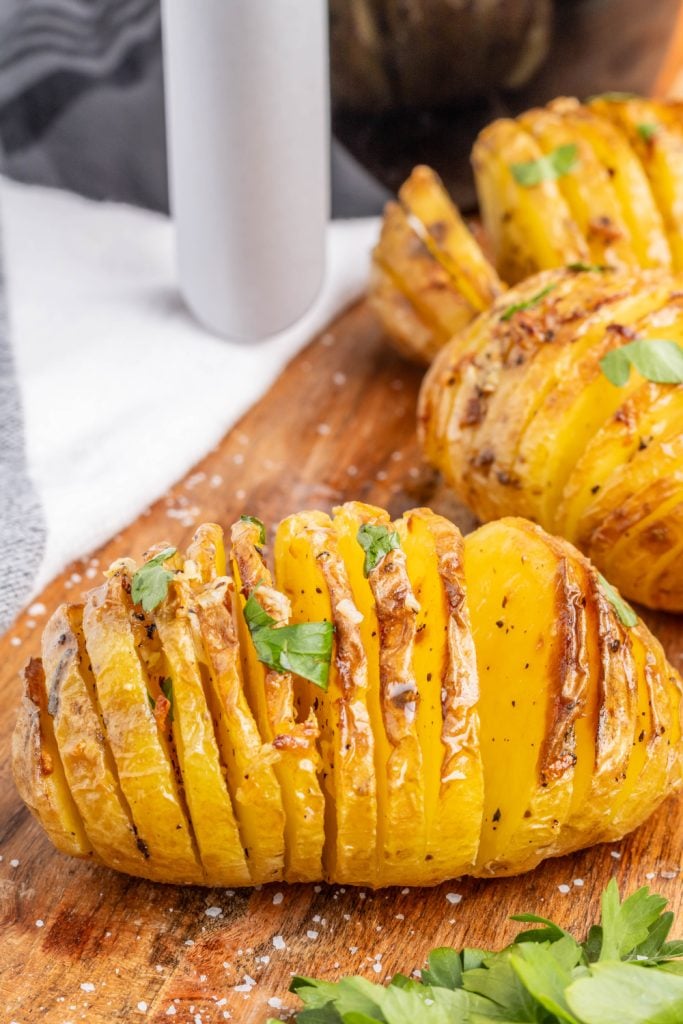 Air Fryer Garlic Creamy Hasselback Potatoes on a Cutting Board