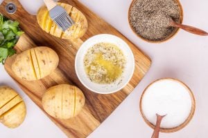 brushing butter mixture over potato