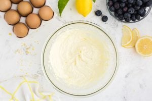 cream cheese, 1/3 cup sugar, lemon juice, lemon zest, and egg mixed in a bowl